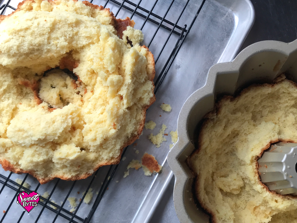 A cake stuck in pan. Half on the cooling rack, half in the bundt pan.