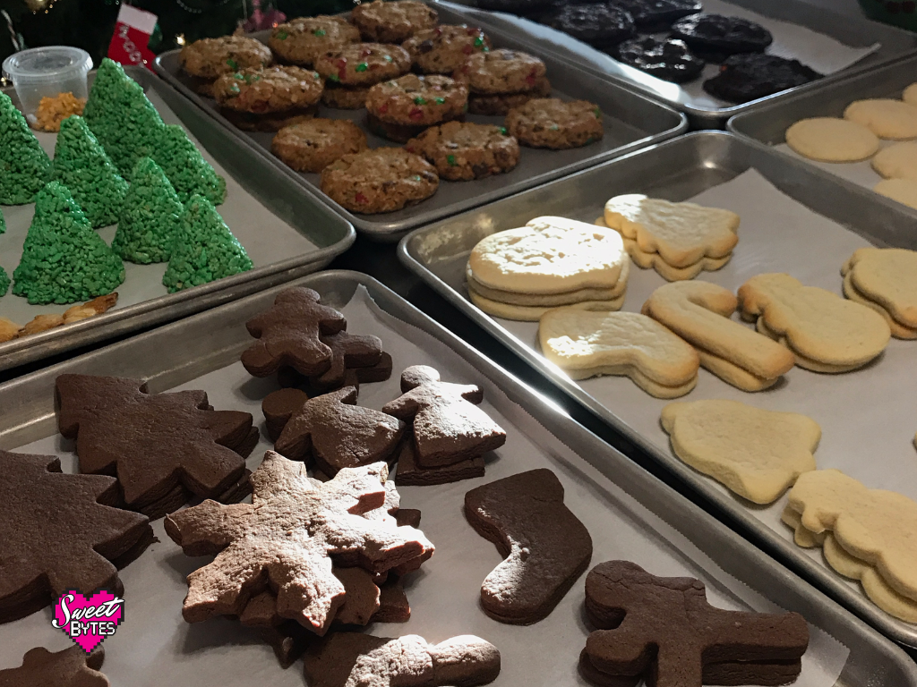 A table full of different types of Christmas cookies for December