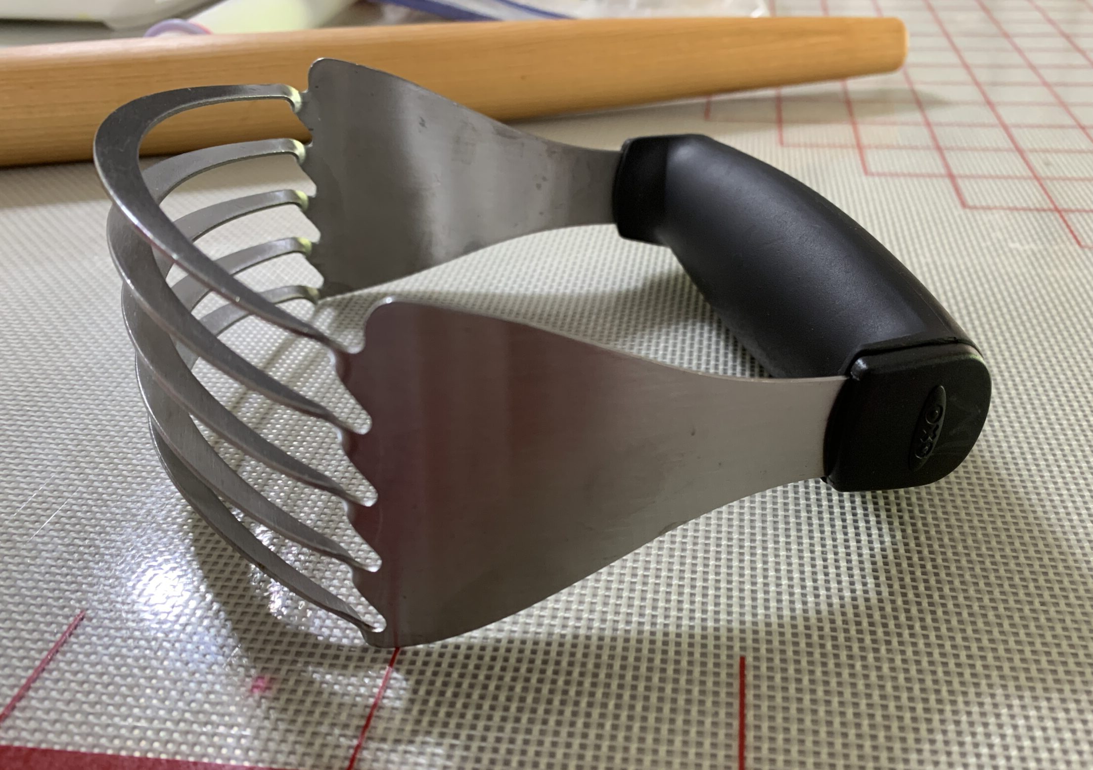 a stainless steel pastry cutter on a silicone mat