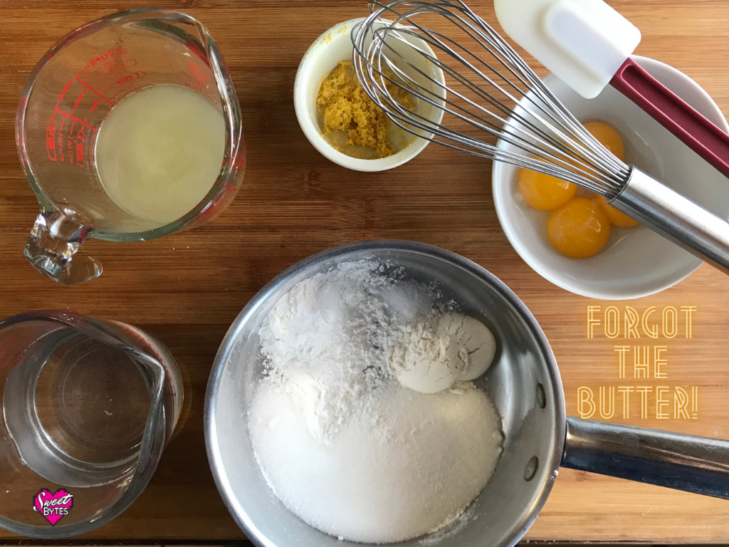 Displayed ingredients for making lemon meringue pie filling: water, lemon juice, lemon zest, egg yolks, sugar, flour, cornstarch, and salt. Text on image says "forgot the butter"