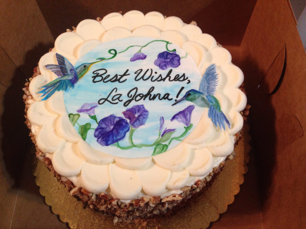 Handpainted hummingbirds on top of a hummingbird cake