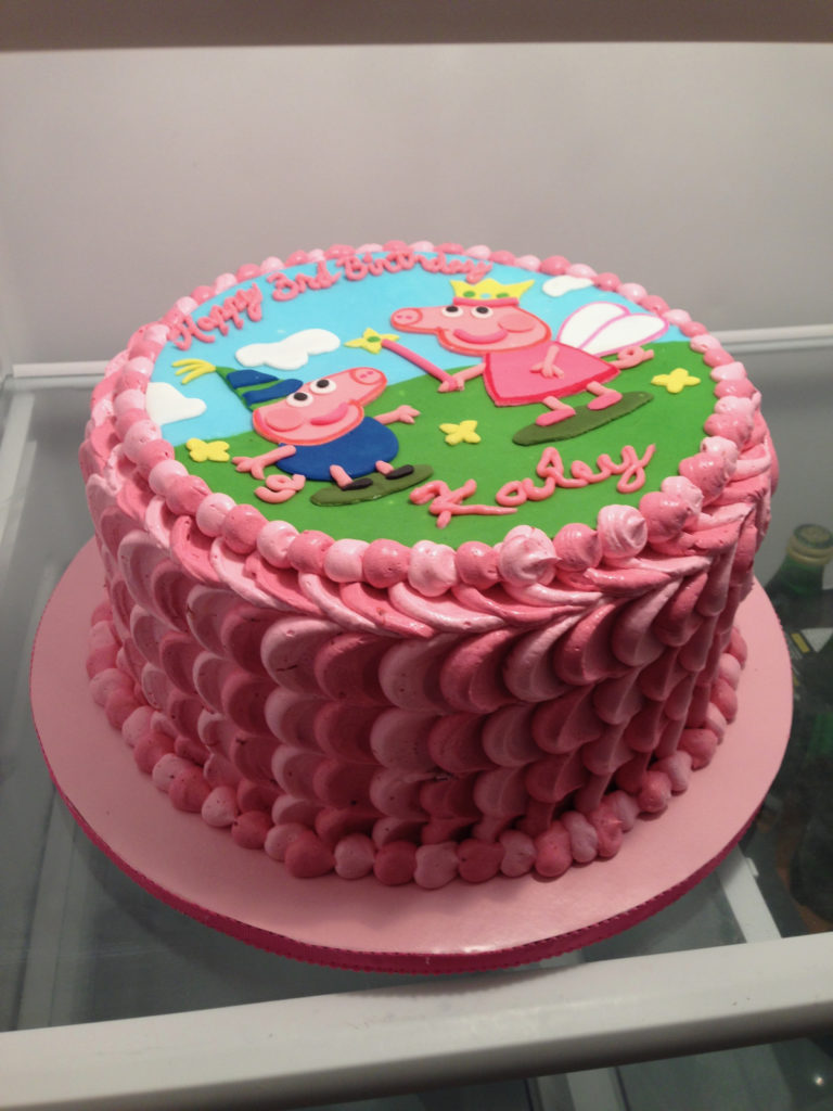 peppa Pig cake with pink ombre buttercream in the refrigerator