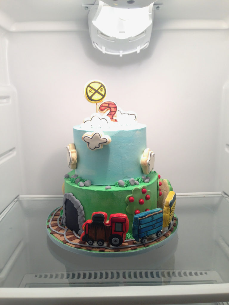 two tiered train cake in the refriferator