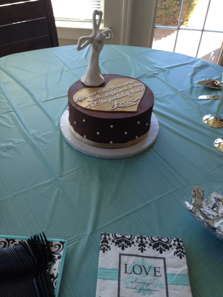 Small Chocolate wedding cake with gold heart in the center